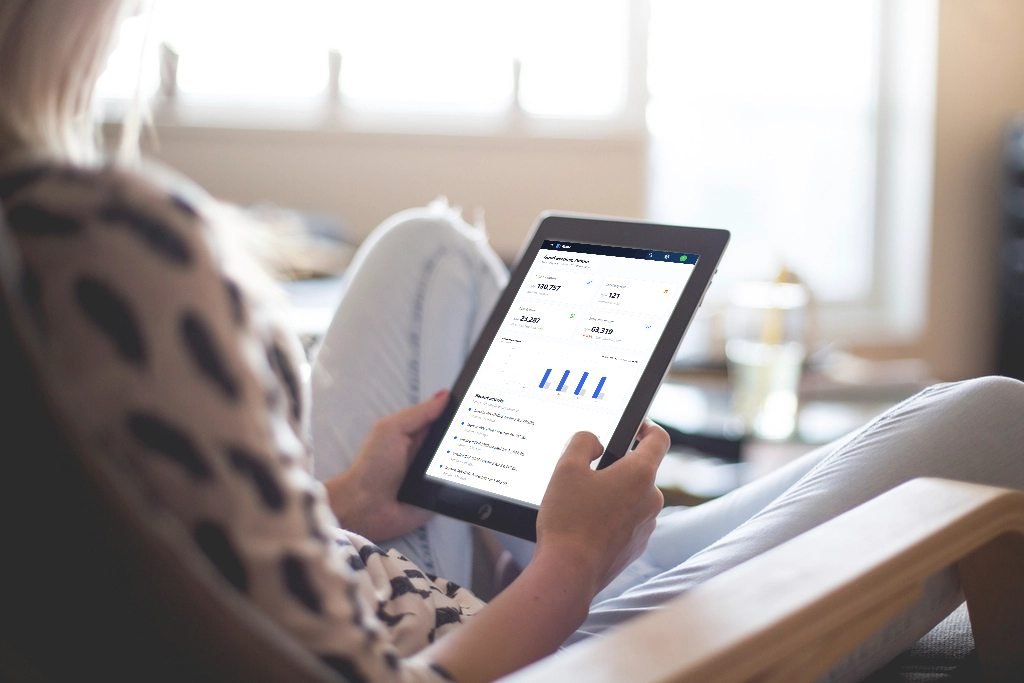 A business owner checking the Fiscal dashboard on a tablet